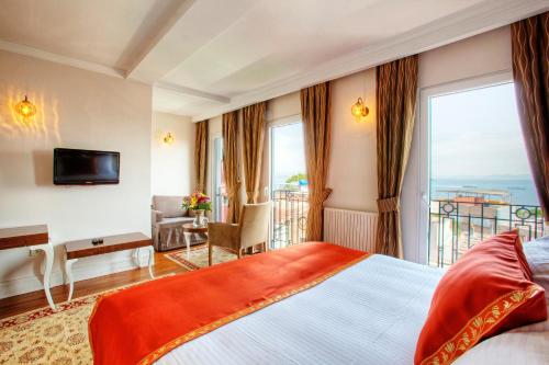 a hotel room with a bed and a balcony at Aren Suites in Istanbul