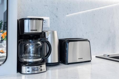a blender and a toaster sitting on a counter at Stunning Views Luxury Studio in Bucharest