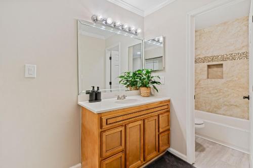 a bathroom with a sink and a mirror at W - Atlanta Luxury 1bdr 1bath ensuite shared Condo in prime location in Atlanta