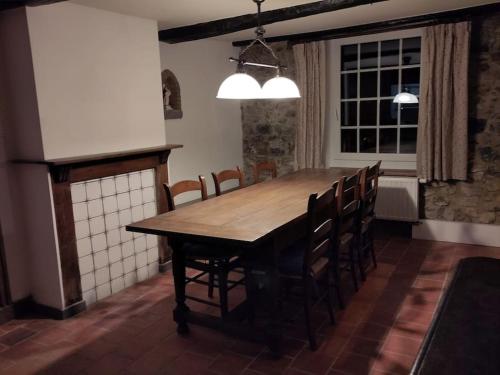 a dining room with a wooden table and chairs at Les Arpents Verts 52 