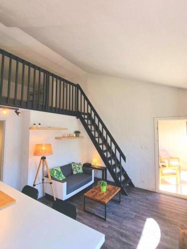 un salon avec un canapé et un escalier dans l'établissement Duplex Cosy - Toulouse, à Toulouse