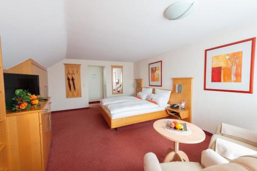 a hotel room with a bed and a couch at Kur- und Wellnesshotel Förch in Bad Wörishofen
