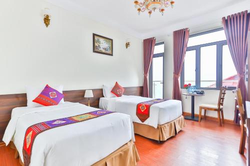 Ένα ή περισσότερα κρεβάτια σε δωμάτιο στο JOVILLE HOTEL SAPA