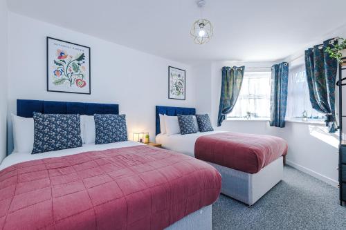 a bedroom with two beds and a window at The Consort Serviced Apartment Coventry in Coventry
