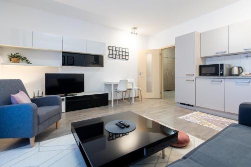 Moravská OstravaにあるNova Karolina Apartmentのソファとテーブルのあるリビングルーム