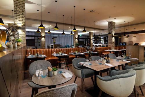 restauracja ze stołami i krzesłami oraz bar w obiekcie Courtyard by Marriott Oxford South w mieście Abingdon