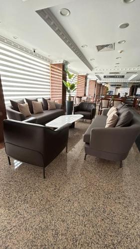 a living room with couches and a table and chairs at Grand Hotel Seferoğlu in Istanbul