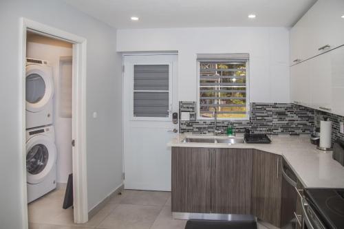 a kitchen with a sink and a washing machine at 246C, South Finger, Waterfront in Jolly Harbour