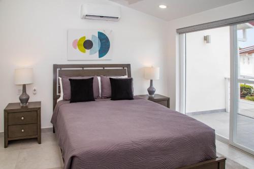 a bedroom with a large bed with two night stands at 232A Upper Level, South Finger Jolly Harbour in Jolly Harbour