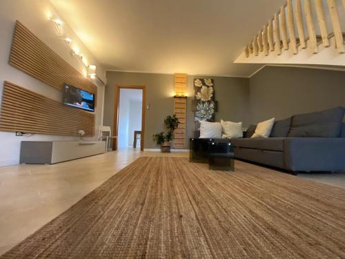 a large living room with a couch and a tv at ProKite Alby Rondina - RESORT - in Birgi Vecchi
