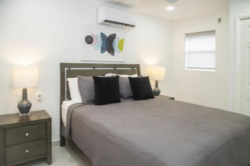 a bedroom with a large bed with two lamps at 232A Lower Level, South Finger, Jolly Harbour in Jolly Harbour