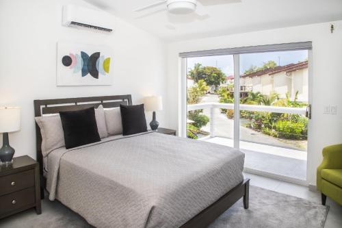 a bedroom with a bed and a large window at 232G Upper Level, South Finger in Jolly Harbour