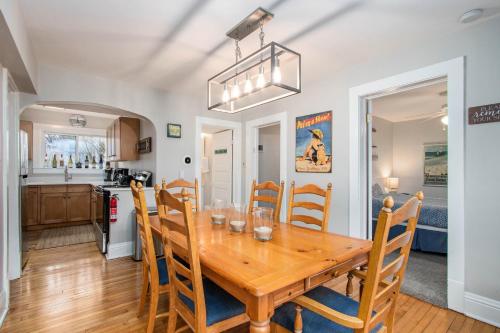 a dining room and kitchen with a wooden table and chairs at Merchant Street Retreat in New Buffalo