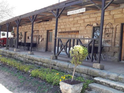 a stone building with a sign on the side of it at Flitwick Ranch in Swartberg