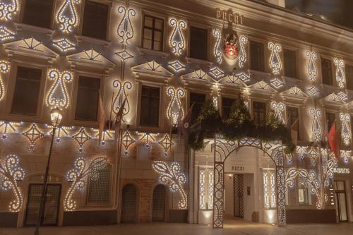 a building decorated with christmas lights and decorations at Hotel Pacai, Vilnius, a Member of Design Hotels in Vilnius