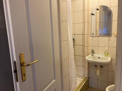 a small bathroom with a sink and a toilet at Leśniczówka Pokoje Gościnne in Gdynia