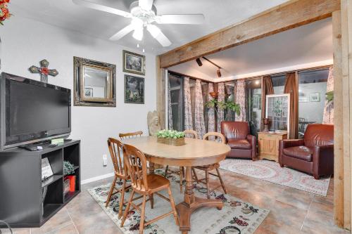 a living room with a table and a tv at Walk to ATandT Stadium! Family Gem with Patio in Arlington