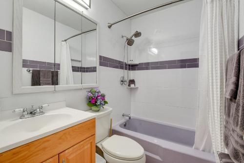 a bathroom with a sink and a toilet and a tub at Walk to ATandT Stadium Arlington Home with Patio! in Arlington