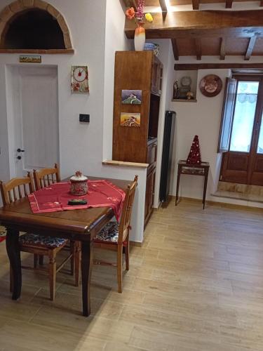 a kitchen with a table and chairs and a refrigerator at La Casa di Olga in Radicofani