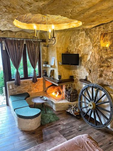 a living room with a couch and a fireplace at Anilia Guesthouse in Synikia Mesi Trikalon
