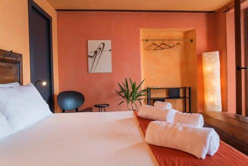 a bedroom with a large white bed and orange walls at Suite 180° - Lago di Como in Blevio