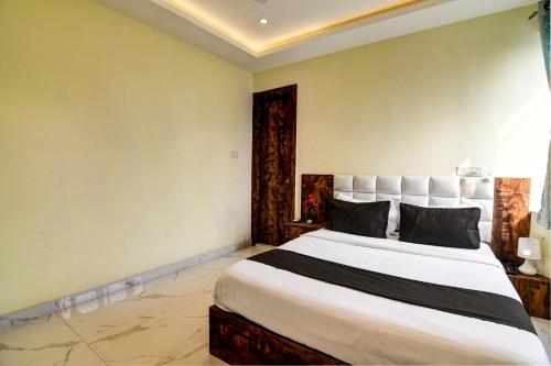 a bedroom with a large bed in a room at The Hastings Club in Kolkata