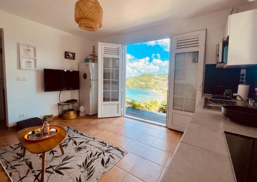 a kitchen with a view of the ocean at L'amour à la plage...vue mer exceptionnelle ! in Les Trois-Îlets