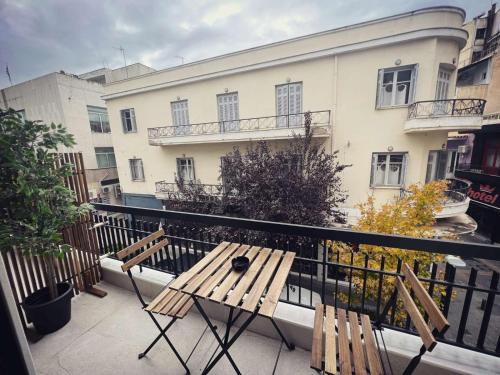 a balcony with two wooden benches and a building at Luxurious wooden detail flat in city center in Chalkida