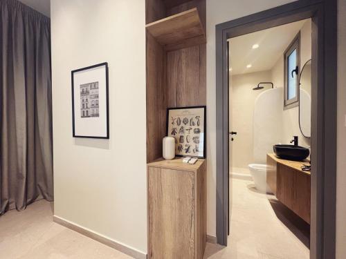 a bathroom with a toilet and a sink at Luxurious wooden detail flat in city center in Chalkida