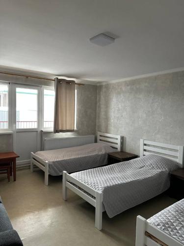 a bedroom with two beds and a couch at Apartment in Kovelʼ