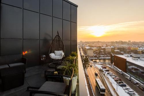 a balcony of a building with a view of a city at Q18 ApartHotel in Bydgoszcz