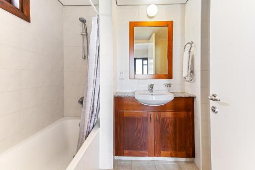a bathroom with a sink and a bath tub at 2 bedroom Apartment Assia with communal pool, Aphrodite Hills Resort in Kouklia