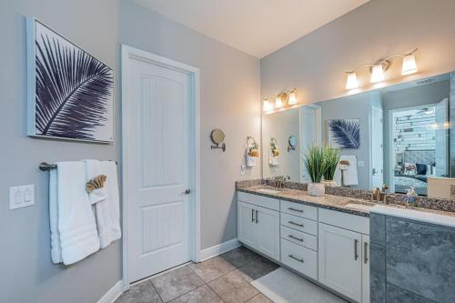 a bathroom with a sink and a large mirror at Tropical Treasure Beach Villa in St. Pete Beach