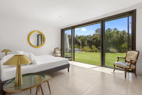 a bedroom with a bed and a glass table at Rez de Villa pour 8 Valeriane in Trans-en-Provence
