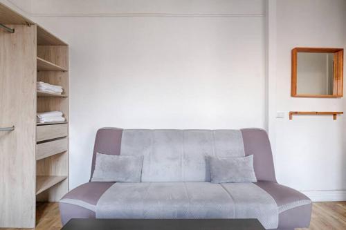 a living room with a couch and a table at Paul-Gillet Cosy Studio 2P in Asnières-sur-Seine