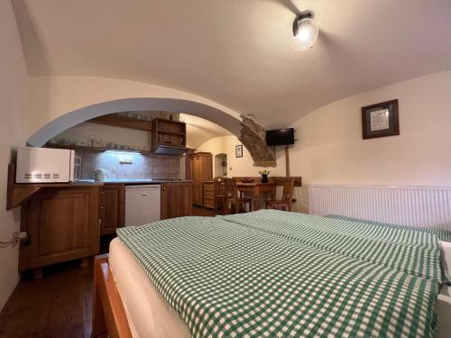 a bedroom with a green and white bed in a room at Penzion Stanský Mlýn in Hlinsko