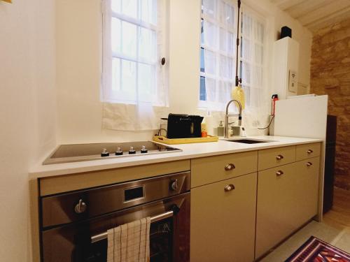 a kitchen with a stove and a sink at Happy Stay Paris - Suite Hotel de Ville le Marais in Paris