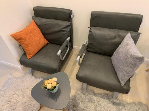 two chairs and a table in a living room at Annex A, a one bedroom Flat in south London in Carshalton