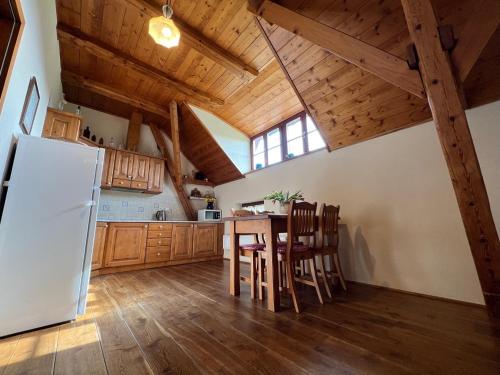 a kitchen with a white refrigerator and wooden cabinets at Penzion Stanský Mlýn in Hlinsko