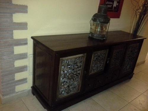 a wooden cabinet with a bottle on top of it at Vogue Hotel Arezzo in Arezzo
