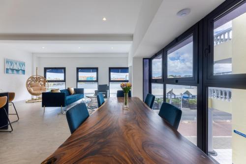 a dining room with a wooden table and chairs at Handelskade Penthouse in Willemstad