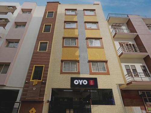 an apartment building with an ovo sign in front of it at OYO 19749 New Shelton Suites in Yelahanka
