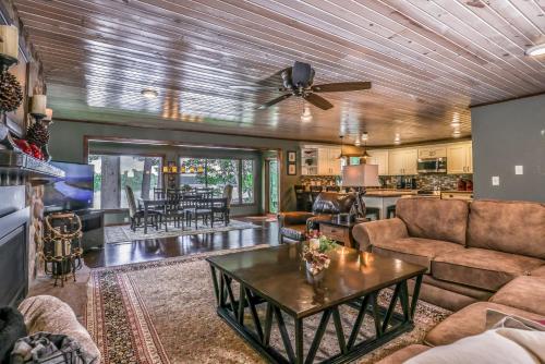 a living room with a couch and a table at Upper Gresham Lakehouse in Manitowish Waters