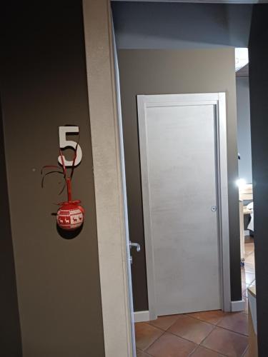 a room with a door with a red car on the wall at locanda della pacchiana in San Salvatore Telesino