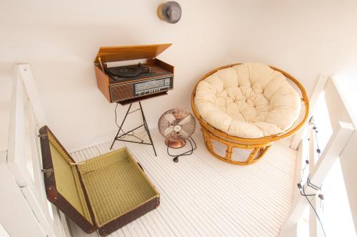 an overhead view of a room with a chair and a radio at Atmospheric studio next to Konecer. Great location in Warsaw