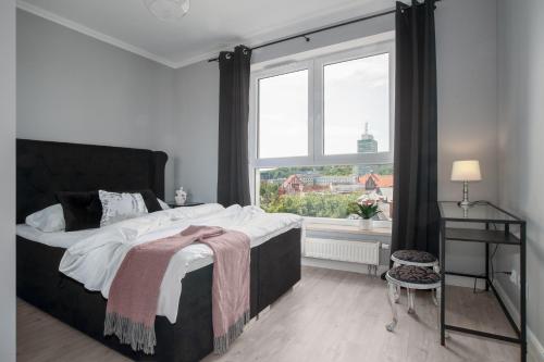A bed or beds in a room at M&J Apartments - Bastion Wałowa