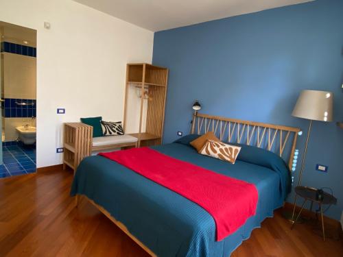 a bedroom with a bed with a red blanket at La Porta Azzurra - Casa Vacanze in Como