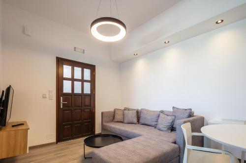 a living room with a couch and a table at Suites Olive Tree Farm Episkopi Village in Episkopí- Rethimno