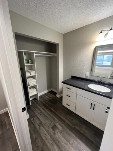 a bathroom with a sink and a mirror at The Patch Lodge in Warroad