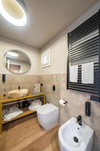 a bathroom with a white toilet and a sink at Palazzo Licinio in Venafro